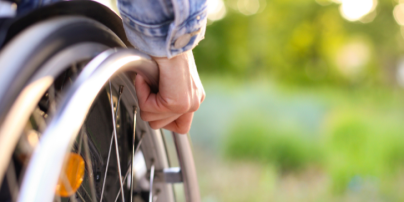Person in a wheelchair, representing the impact of recent changes to NDIS funding on disability support services.