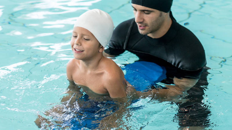 Person performing hydrotherapy exercises in a pool as part of a guided rehabilitation session, demonstrating low-impact aquatic therapy techniques.