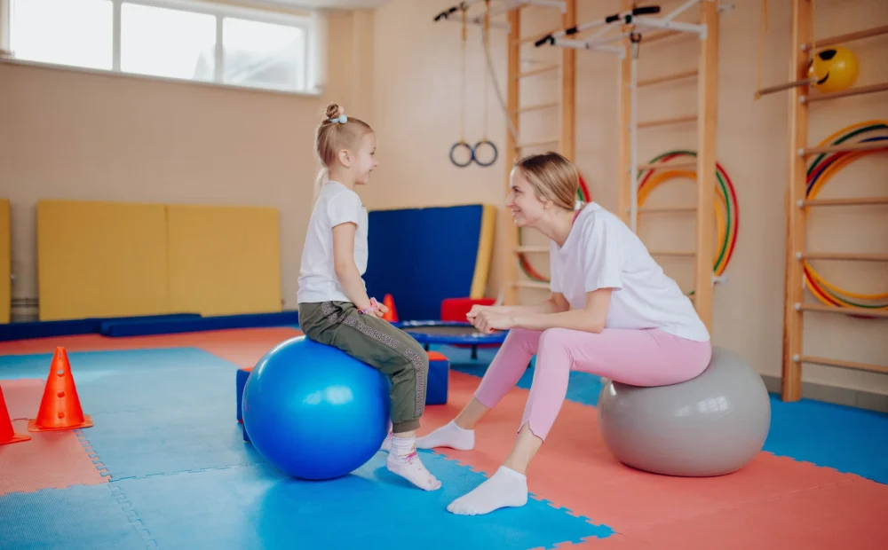 A kid sitting in a ball